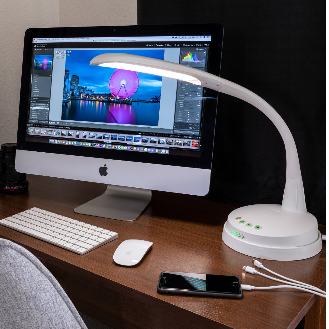 Stella GO rechargeable task lamp illuminating a home office setup